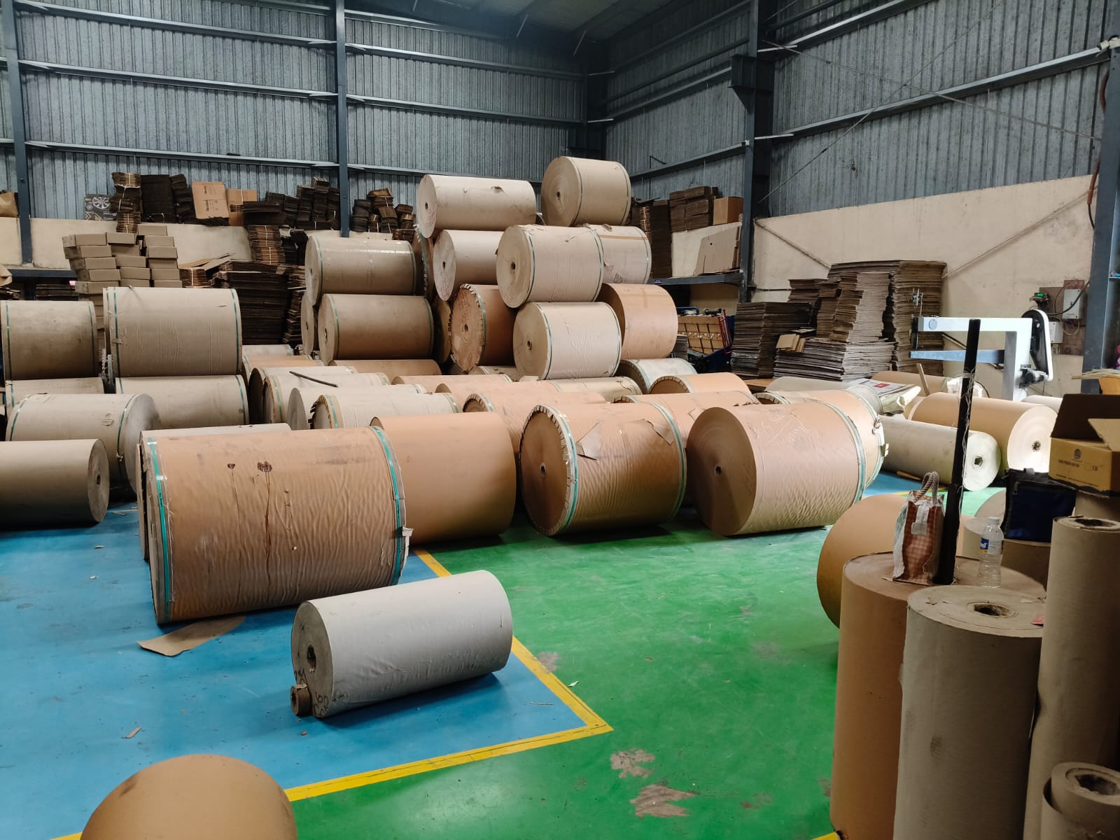 Paper rolls and corrugated stock in production area